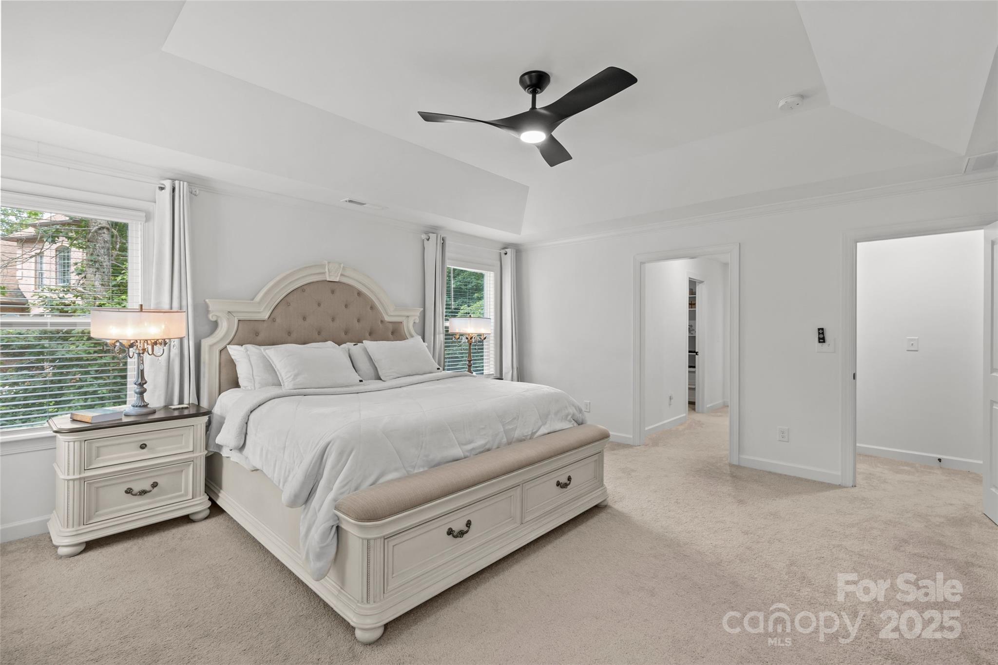 5902 Beatties Ford Road Charlotte, NC 28216 - Photo 26 of 48 a spacious bedroom with a bed a window and a ceiling fan