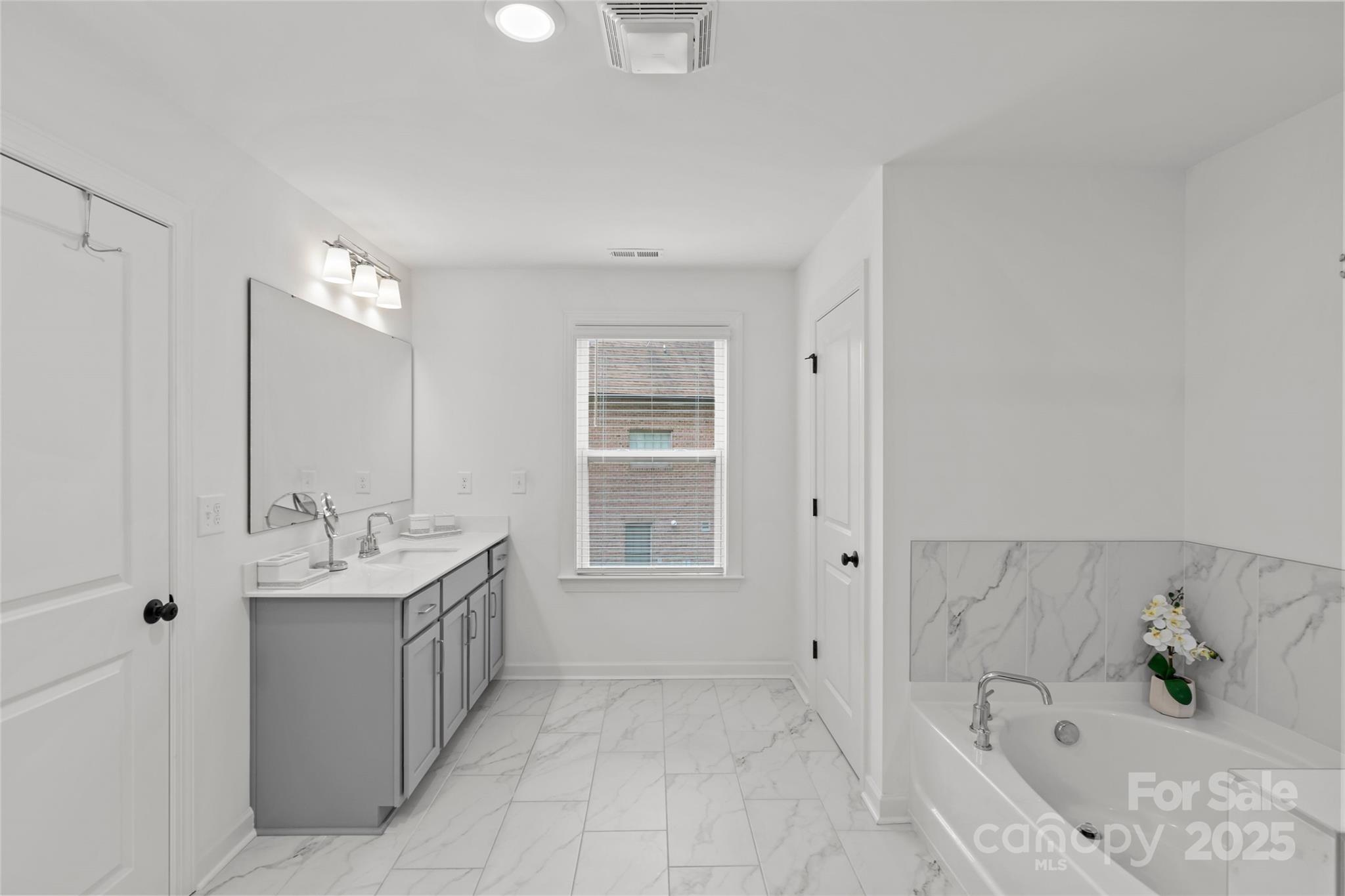 5902 Beatties Ford Road Charlotte, NC 28216 - Photo 28 of 48 a bathroom with a tub sink and mirror