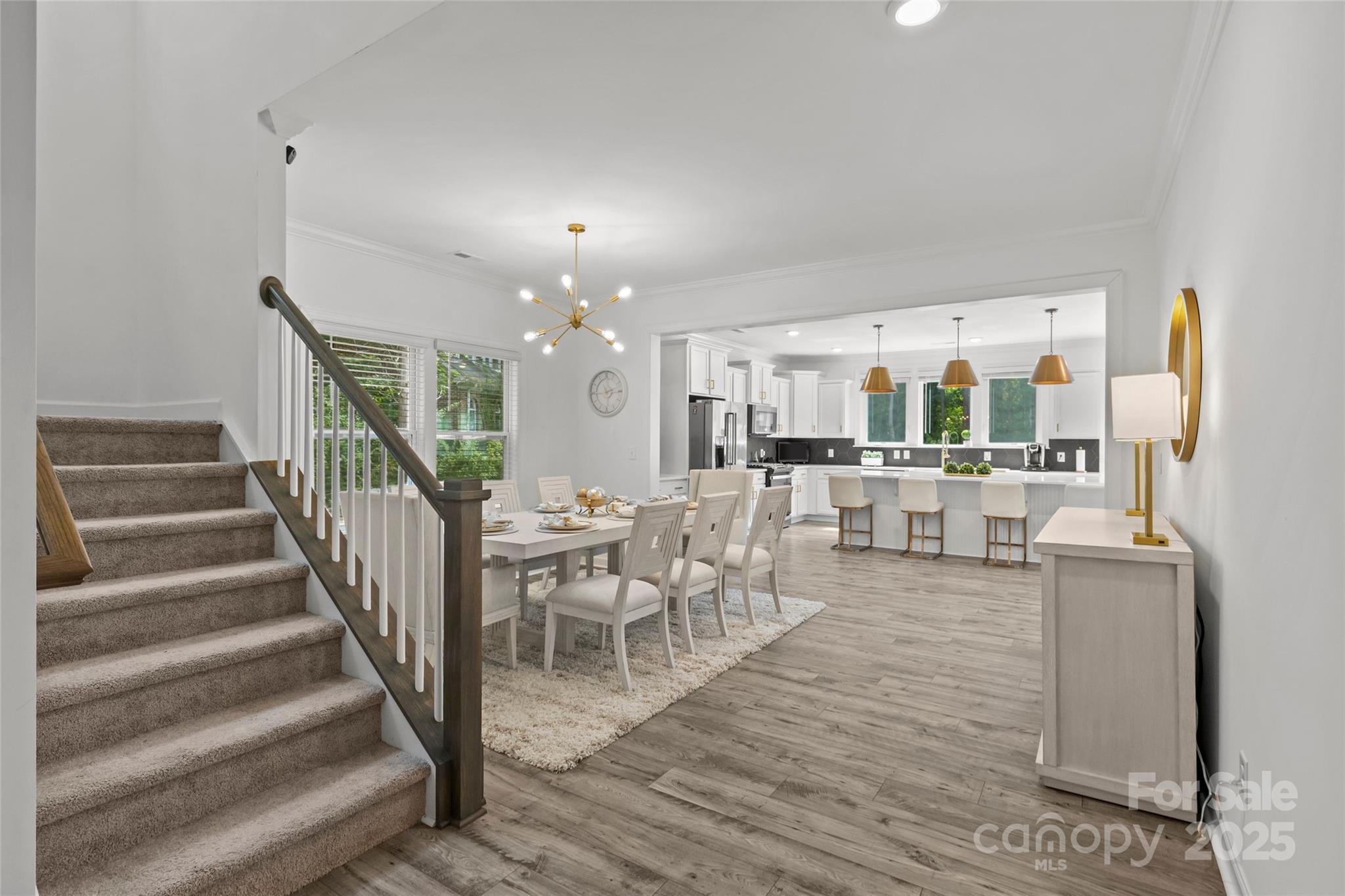 5902 Beatties Ford Road Charlotte, NC 28216 - Photo 5 of 48 a living room with furniture and a dining table with chandelier