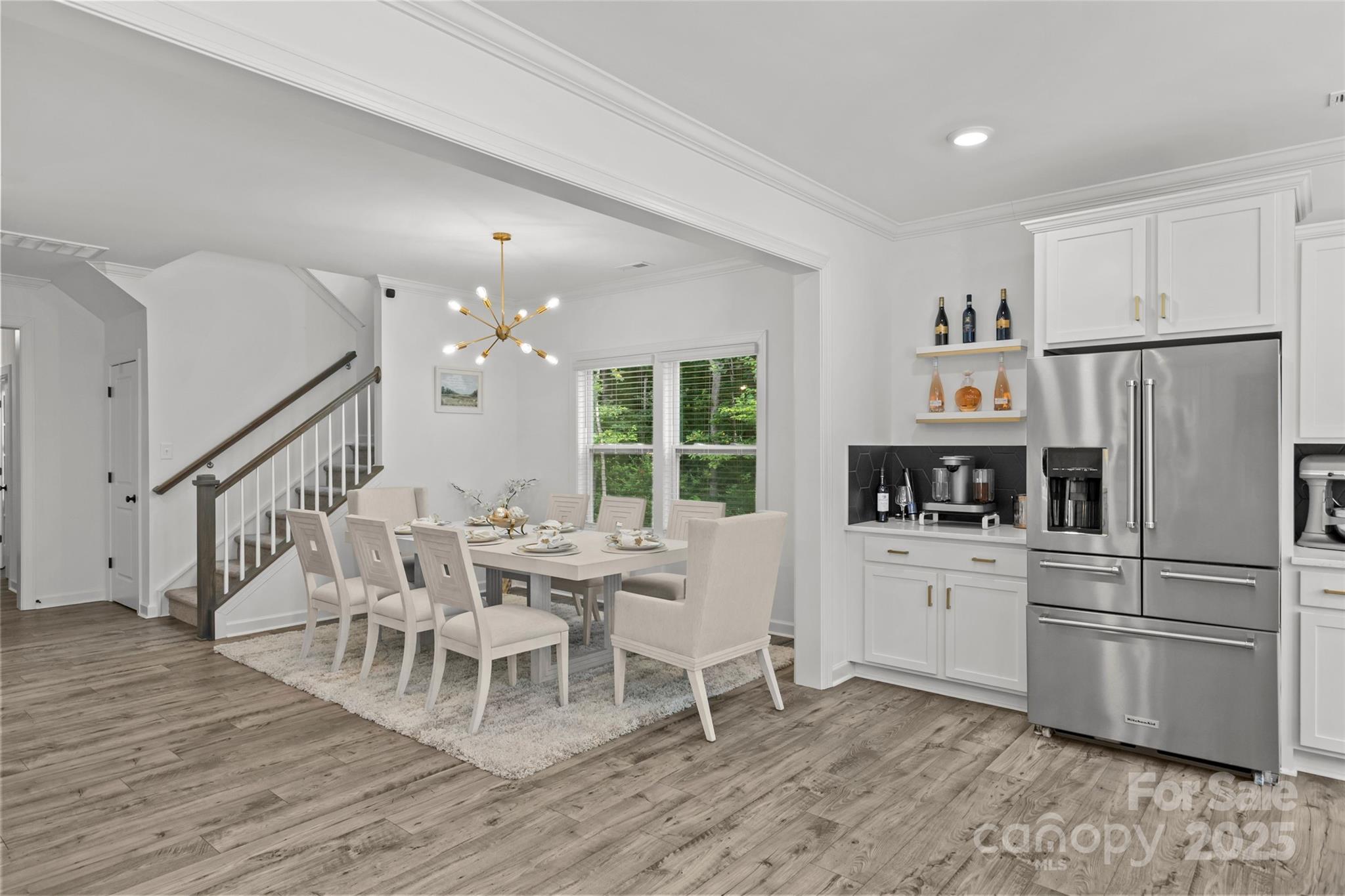 5902 Beatties Ford Road Charlotte, NC 28216 - Photo 9 of 48 a kitchen with white cabinets and stainless steel appliances