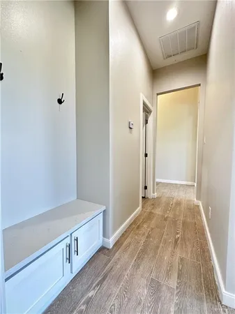 a view of an empty room with wooden floor