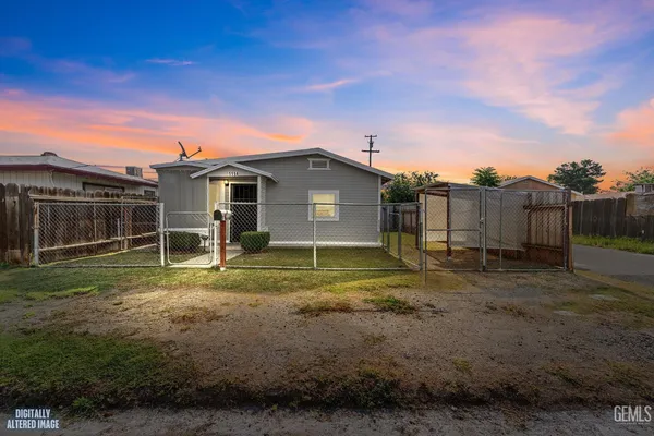 a view of a backyard with wooden fence