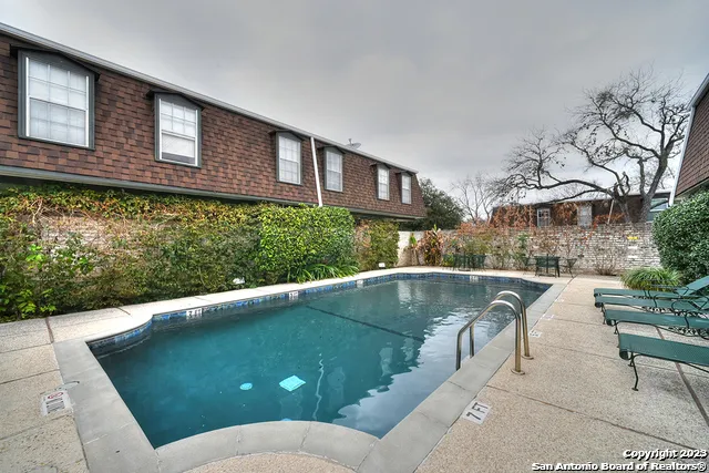 a view of a swimming pool with a patio