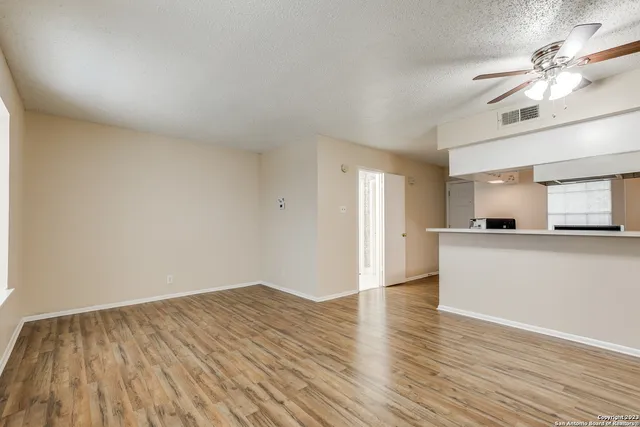 a view of a kitchen with wooden floor and a sink