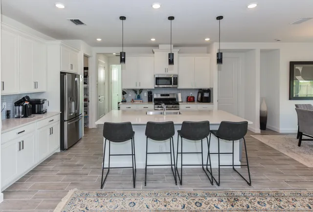 a bathroom with a double vanity sink mirror and shower
