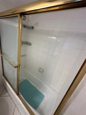 a bathroom with a shower and a tub