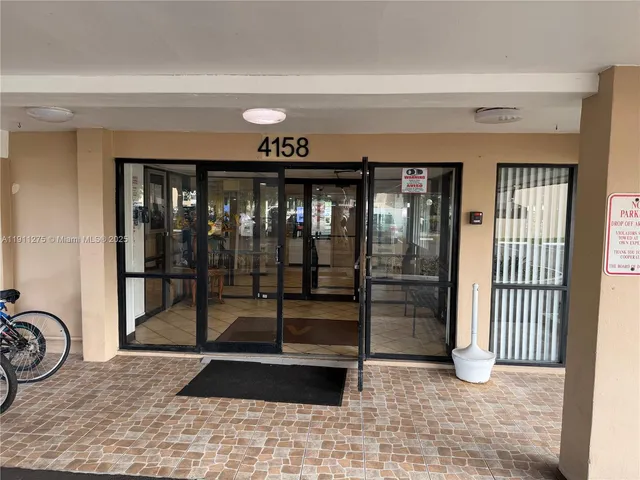 a view of a porch with a door and wooden floor