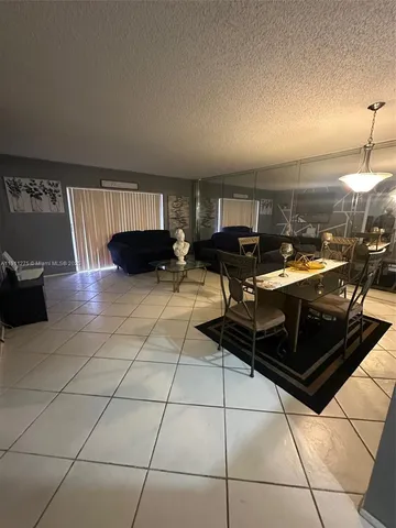 a kitchen with a sink a counter and chairs