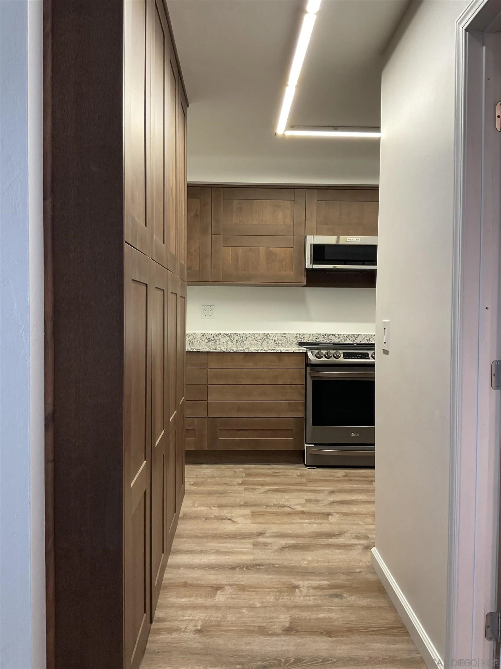 2600 Torrey Pines Road, Unit A25 La Jolla, CA 92037 - Photo 12 of 47 a kitchen with stainless steel appliances a stove and a refrigerator