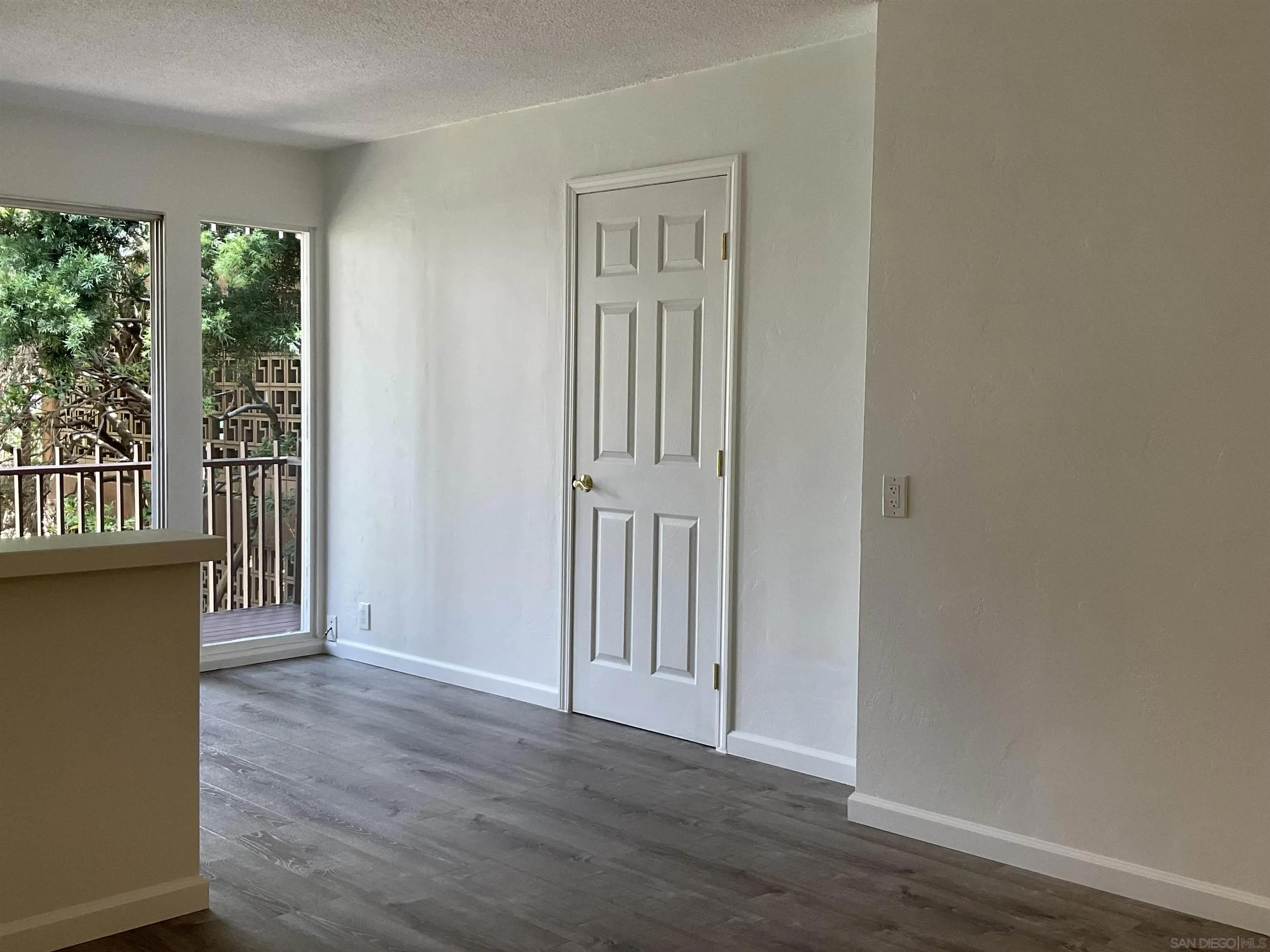2600 Torrey Pines Road, Unit A25 La Jolla, CA 92037 - Photo 17 of 47 an empty room with wooden floor and a window