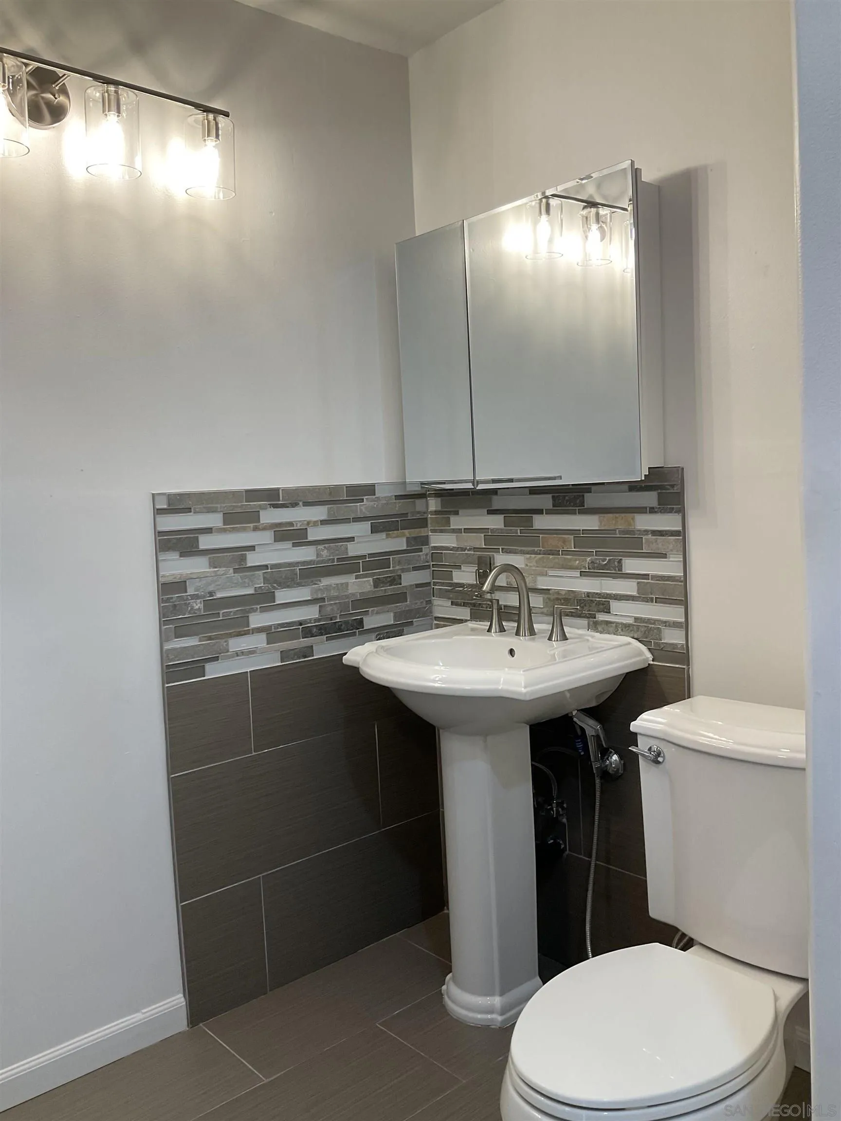 2600 Torrey Pines Road, Unit A25 La Jolla, CA 92037 - Photo 36 of 47 a bathroom with a sink toilet and mirror