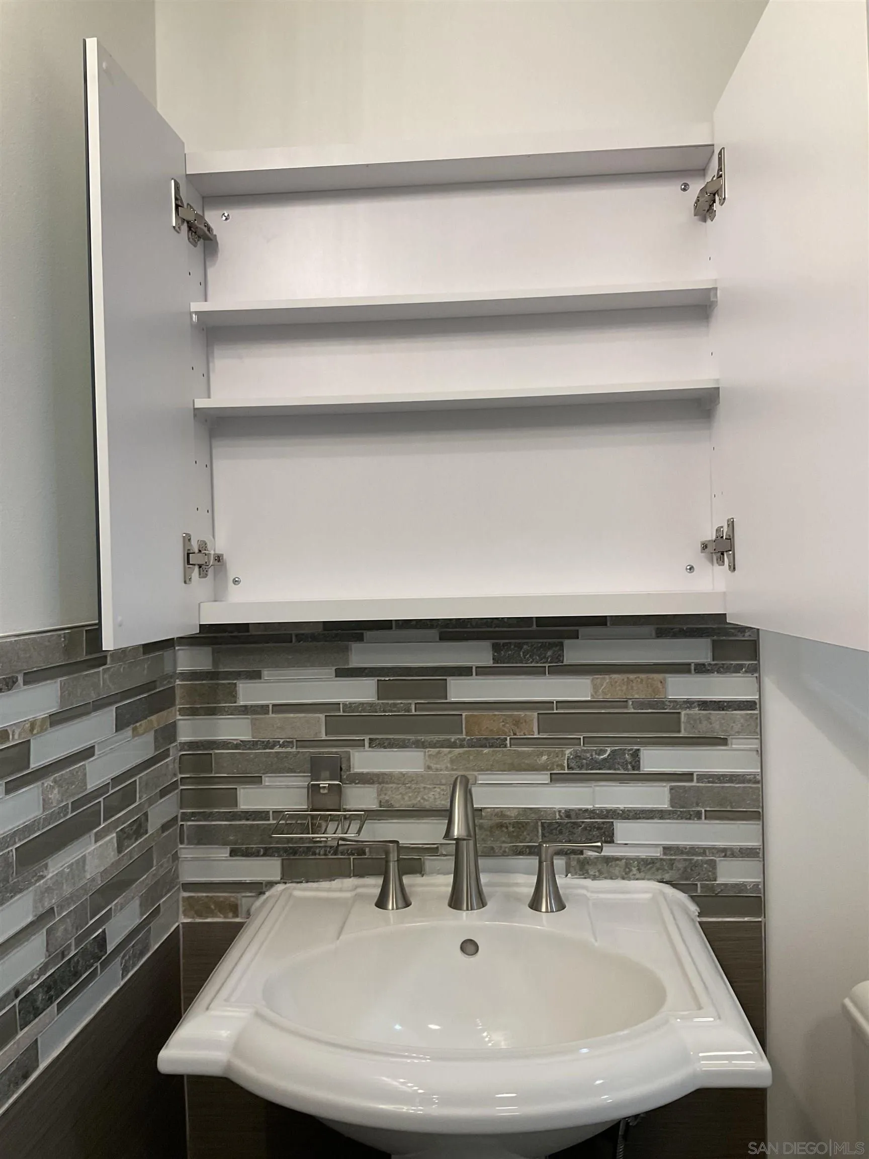 2600 Torrey Pines Road, Unit A25 La Jolla, CA 92037 - Photo 37 of 47 a bathroom with a sink and a mirror