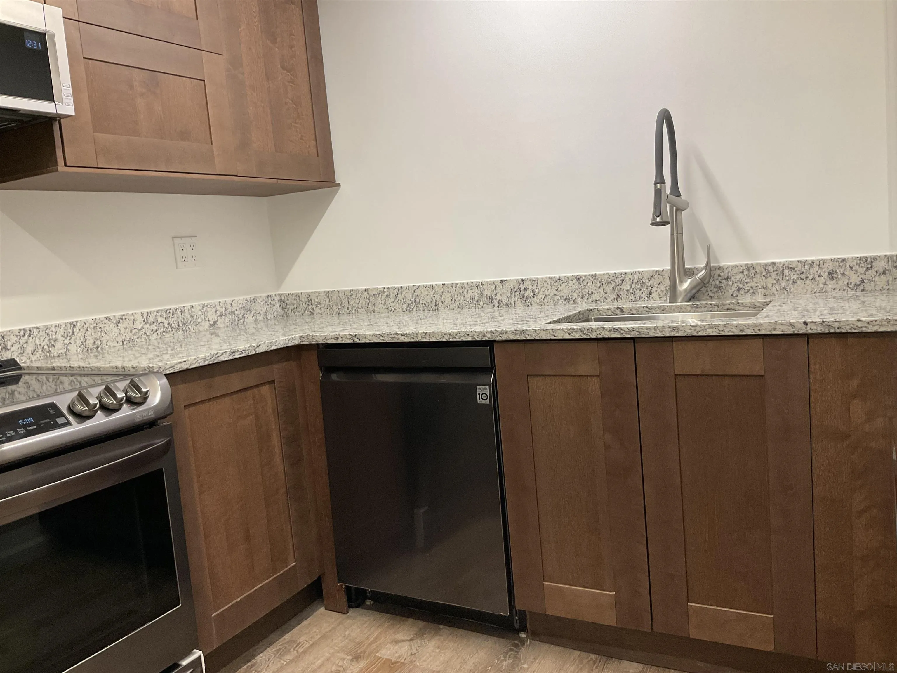 2600 Torrey Pines Road, Unit A25 La Jolla, CA 92037 - Photo 5 of 47 a kitchen with granite countertop a sink and a stove