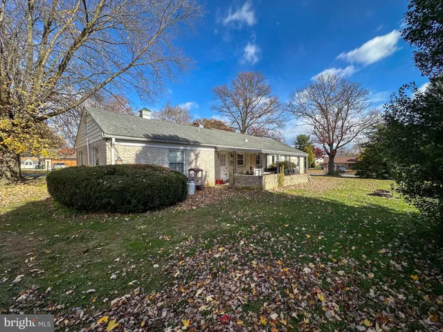 a view of house with yard and green space