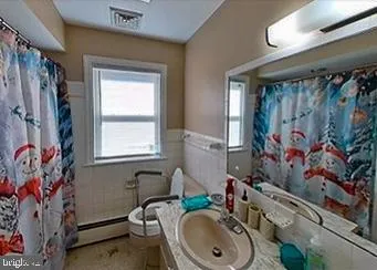 a bathroom with a sink a toilet and a window
