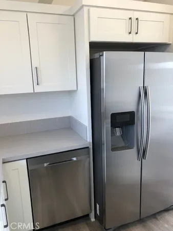 a kitchen with a refrigerator and cabinets