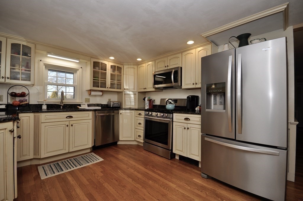 316 Shore Road Bourne, MA 02532 - Photo 15 of 39 a kitchen with white cabinets stainless steel appliances and window