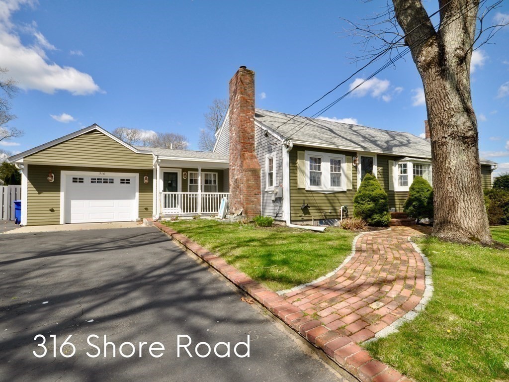 316 Shore Road Bourne, MA 02532 - Photo 3 of 39 a front view of a house with a garden