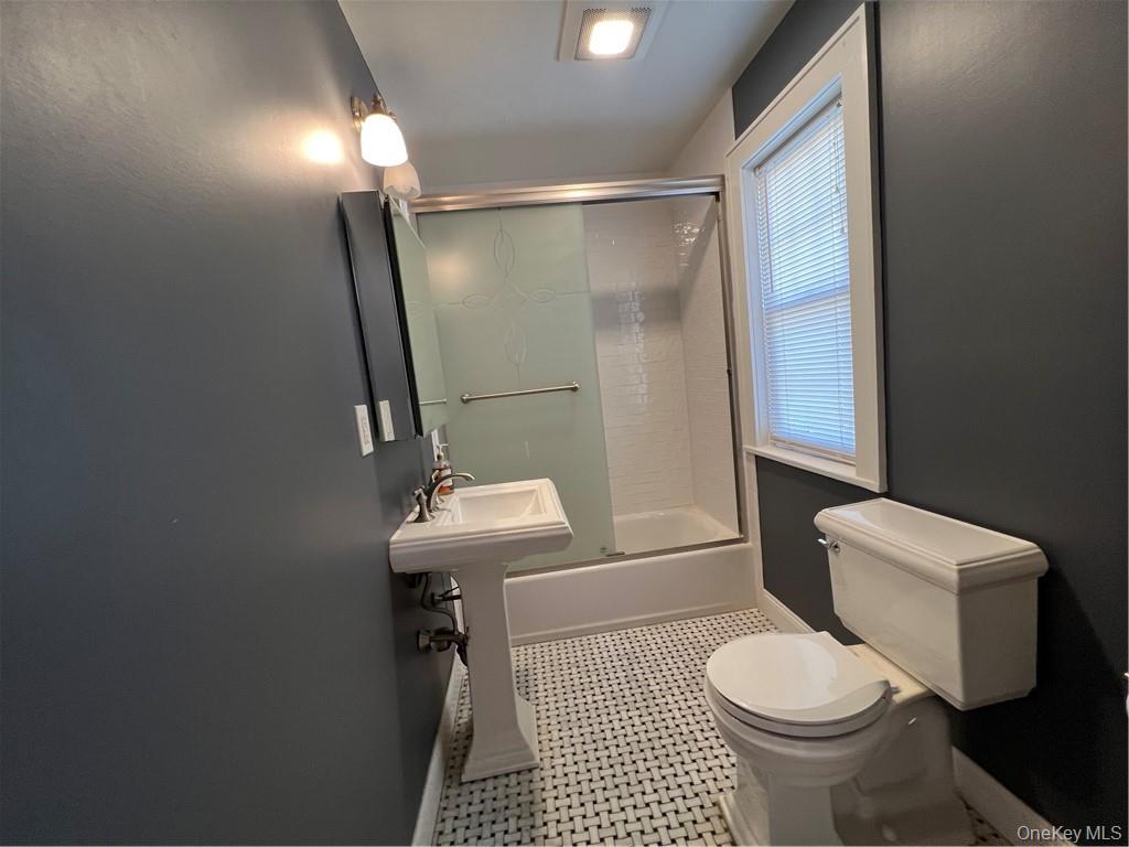 85 Locust Avenue Scarsdale, NY 10583 - Photo 19 of 38 a bathroom with a sink a toilet a mirror and shower