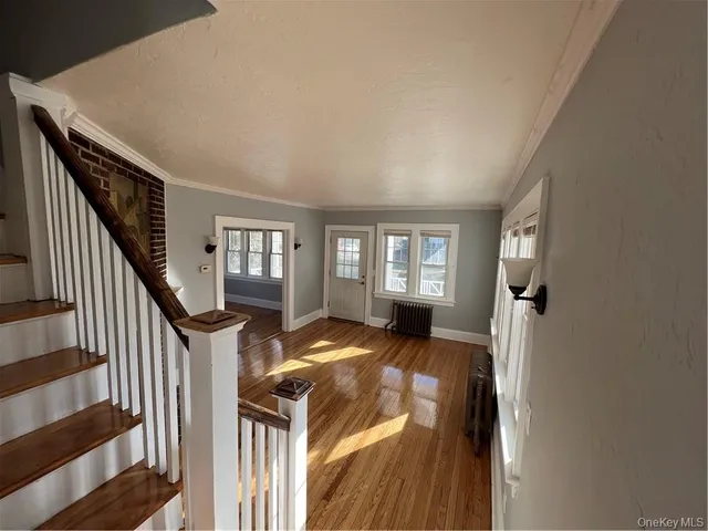 a view of a livingroom with furniture and staircase