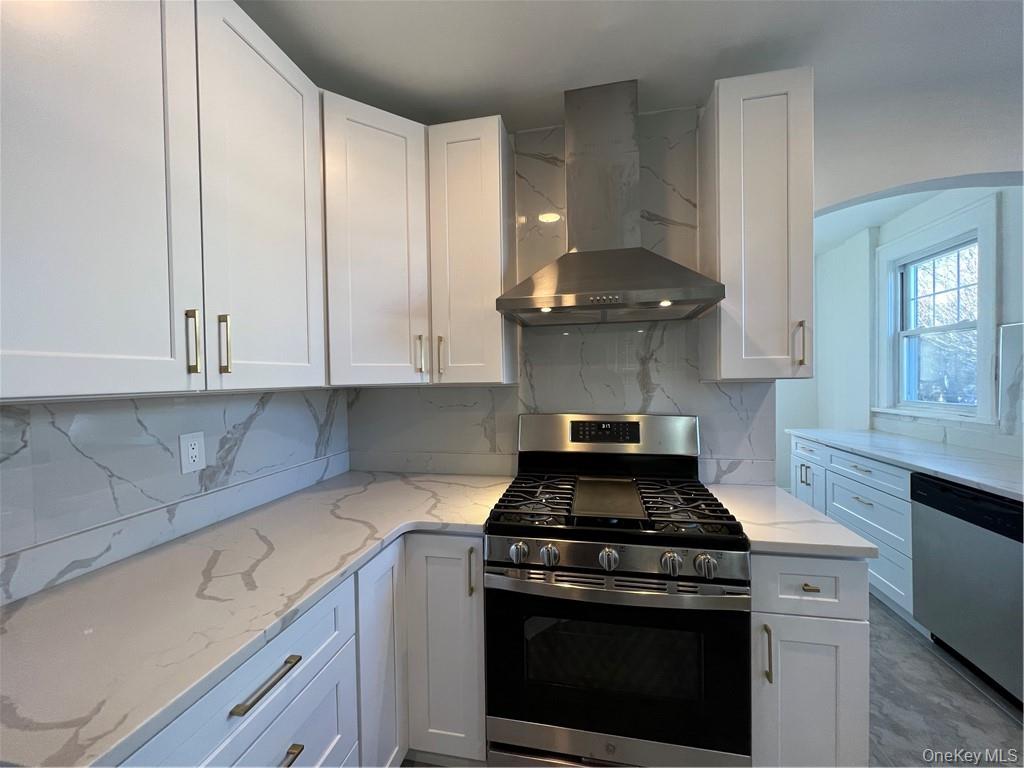85 Locust Avenue Scarsdale, NY 10583 - Photo 2 of 38 a kitchen with stainless steel appliances granite countertop a stove a sink and white cabinets