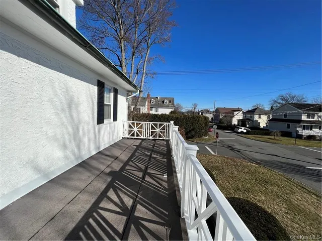 a view of a balcony with car parked