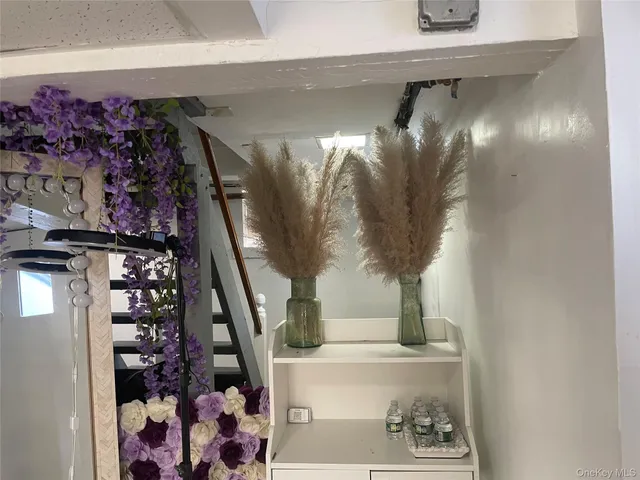 a view of entryway with paintings on the wall