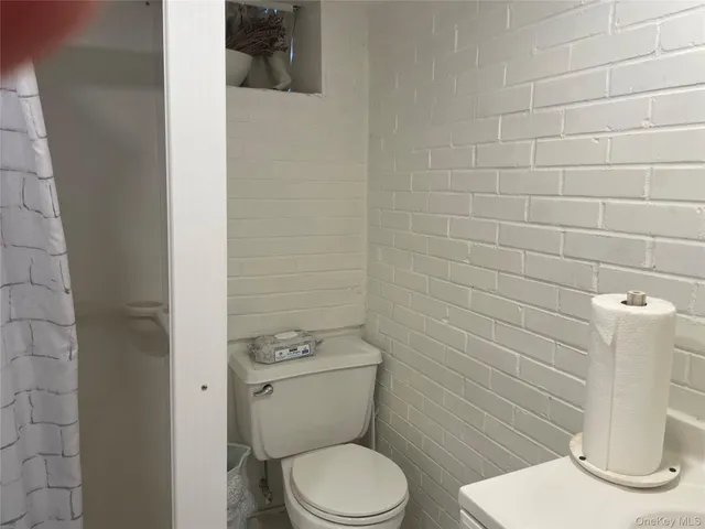 a white toilet sitting next to a bathroom sink