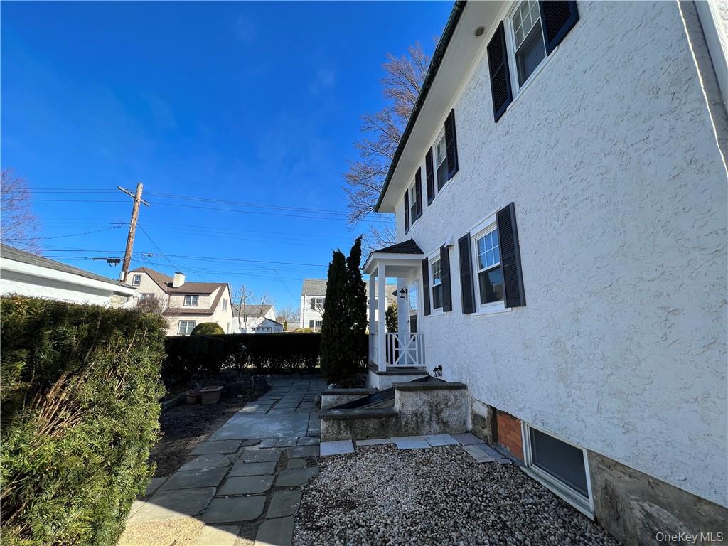 85 Locust Avenue Scarsdale, NY 10583 - Photo 6 of 38 a bench in front of building