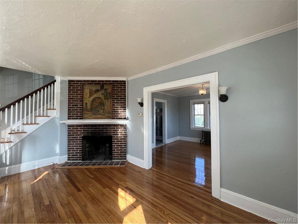 85 Locust Avenue Scarsdale, NY 10583 - Photo 9 of 38 a view of an empty room with wooden floor fireplace and a window