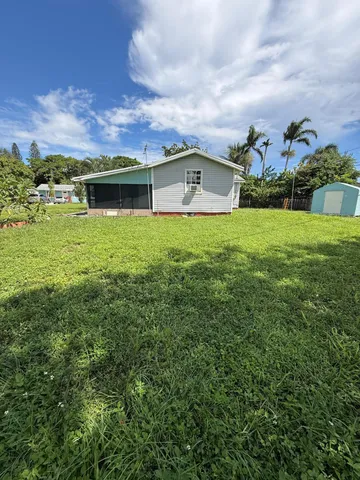 a front view of house with yard and mountain
