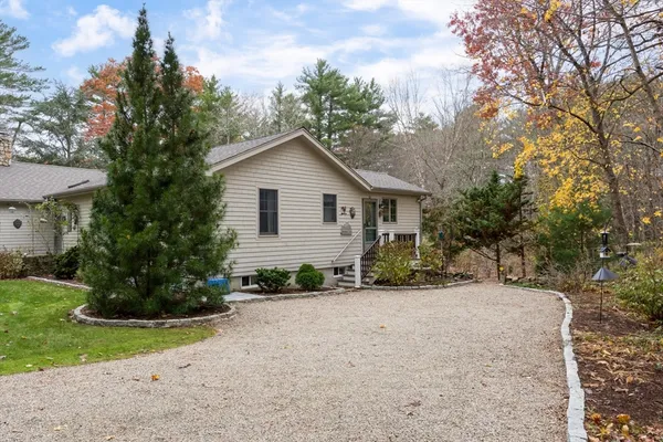 a view of a house with a yard and plants