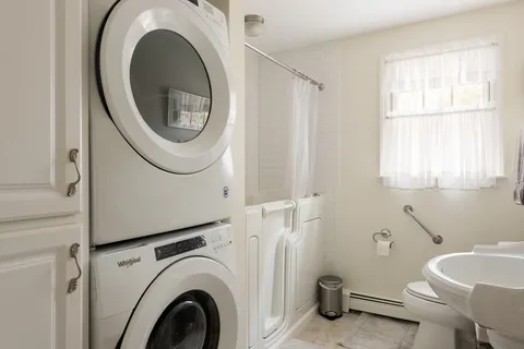 a bathroom with a toilet a sink and a mirror