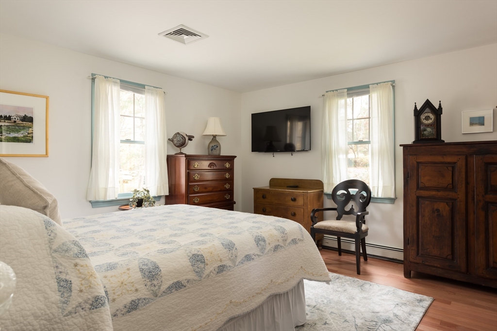 15 Parlowtown Road, Unit A Marion, MA 02738 - Photo 13 of 16 a bedroom with a bed and furniture with wooden floor