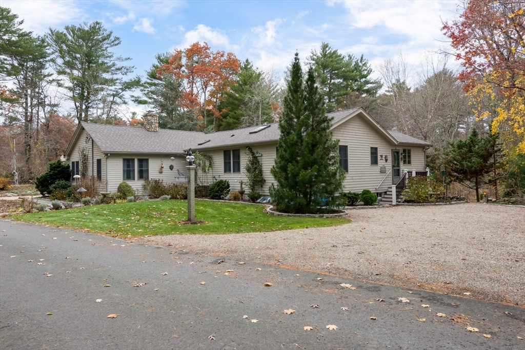 15 Parlowtown Road, Unit A Marion, MA 02738 - Photo 2 of 16 a view of a house with a yard and large trees
