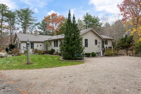 a front view of a house with a yard and a garage