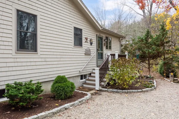 a view of a house with a yard and potted plants