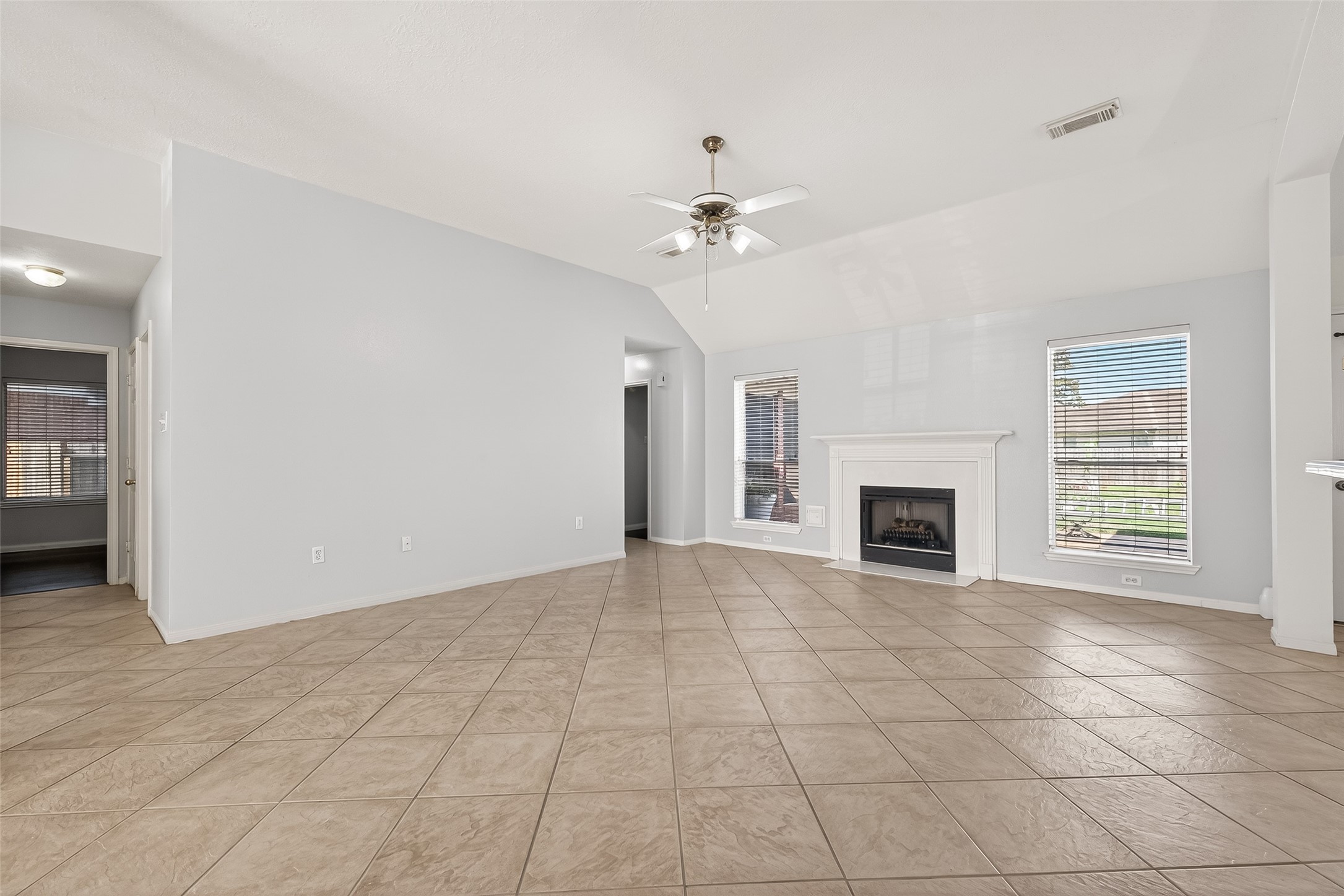 20839 Rivershire Lane Houston, TX 77073 - Photo 13 of 50 a view of an empty room with a fireplace and a window
