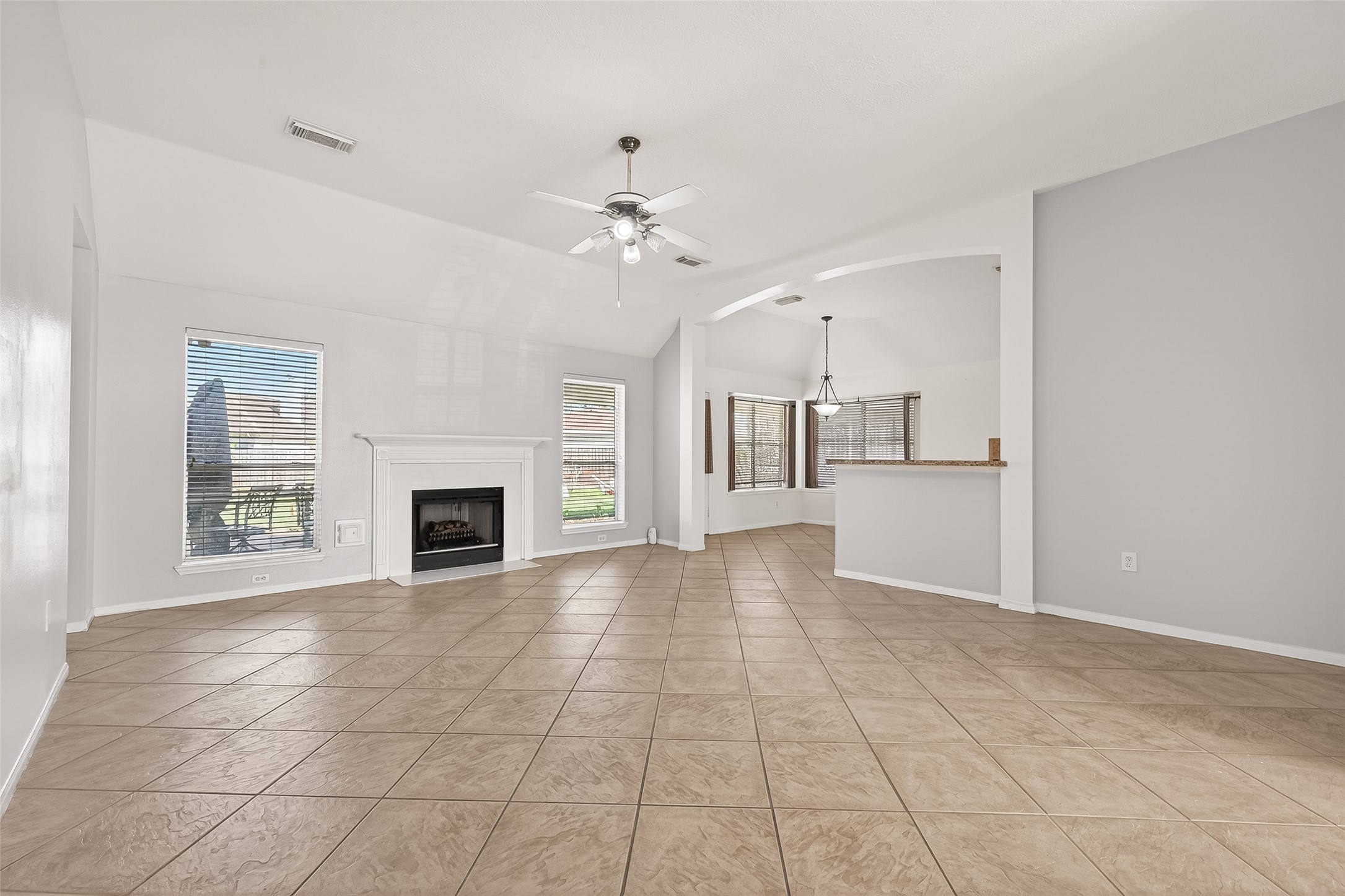 20839 Rivershire Lane Houston, TX 77073 - Photo 14 of 50 a view of an empty room with a fireplace and a window