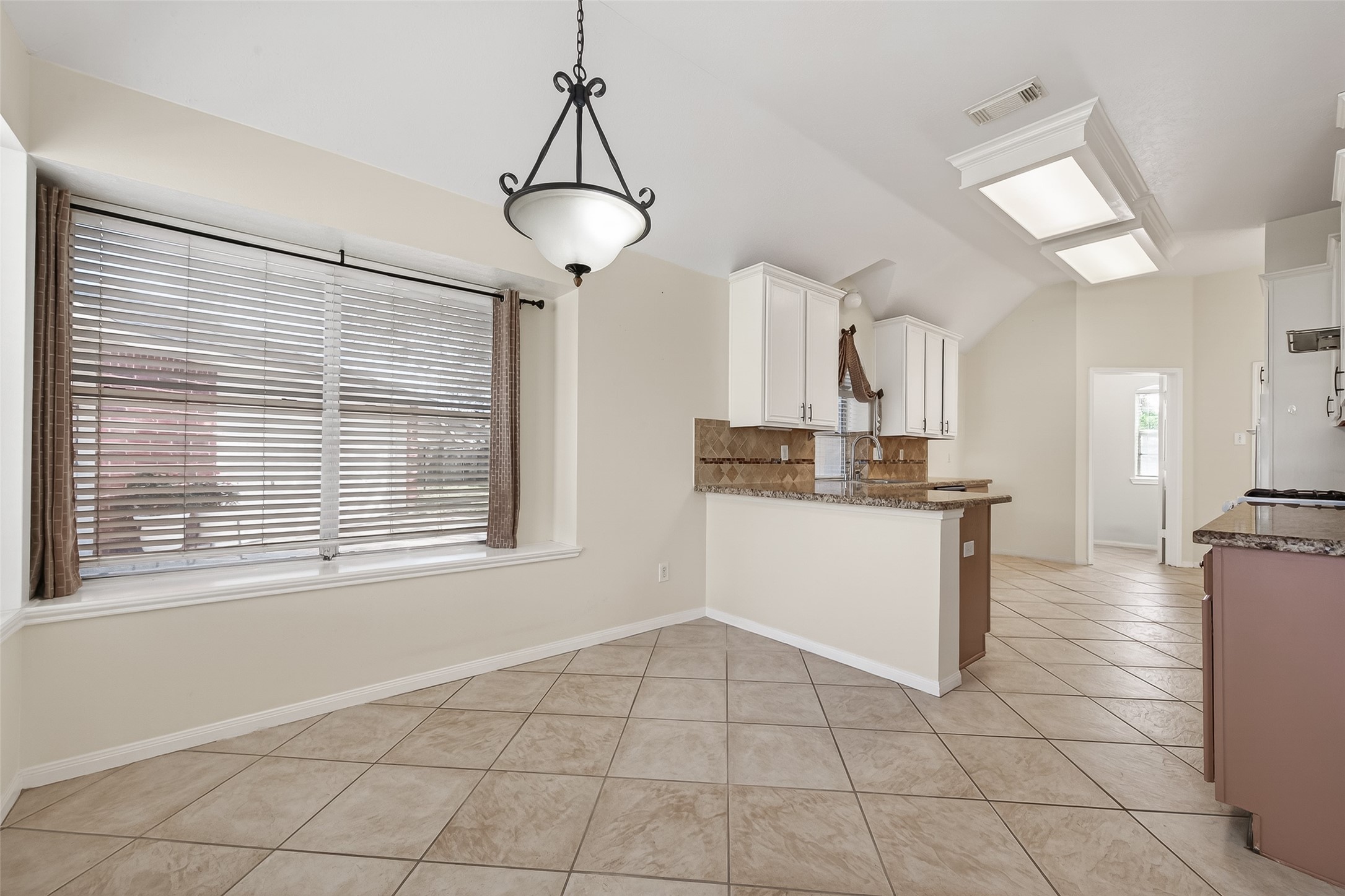 20839 Rivershire Lane Houston, TX 77073 - Photo 16 of 50 a kitchen with white cabinets and window