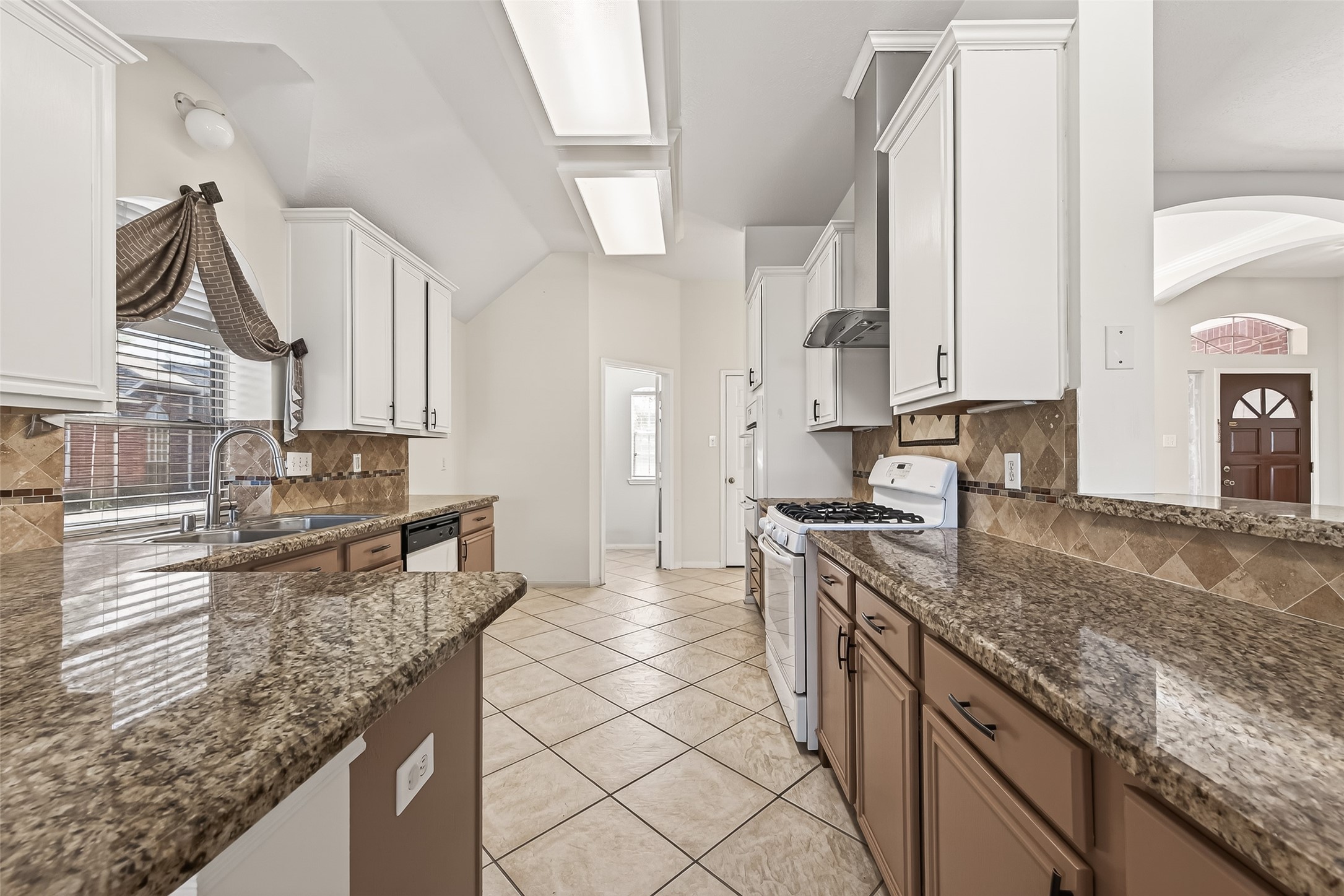20839 Rivershire Lane Houston, TX 77073 - Photo 19 of 50 a kitchen with stainless steel appliances granite countertop a sink stove and cabinets