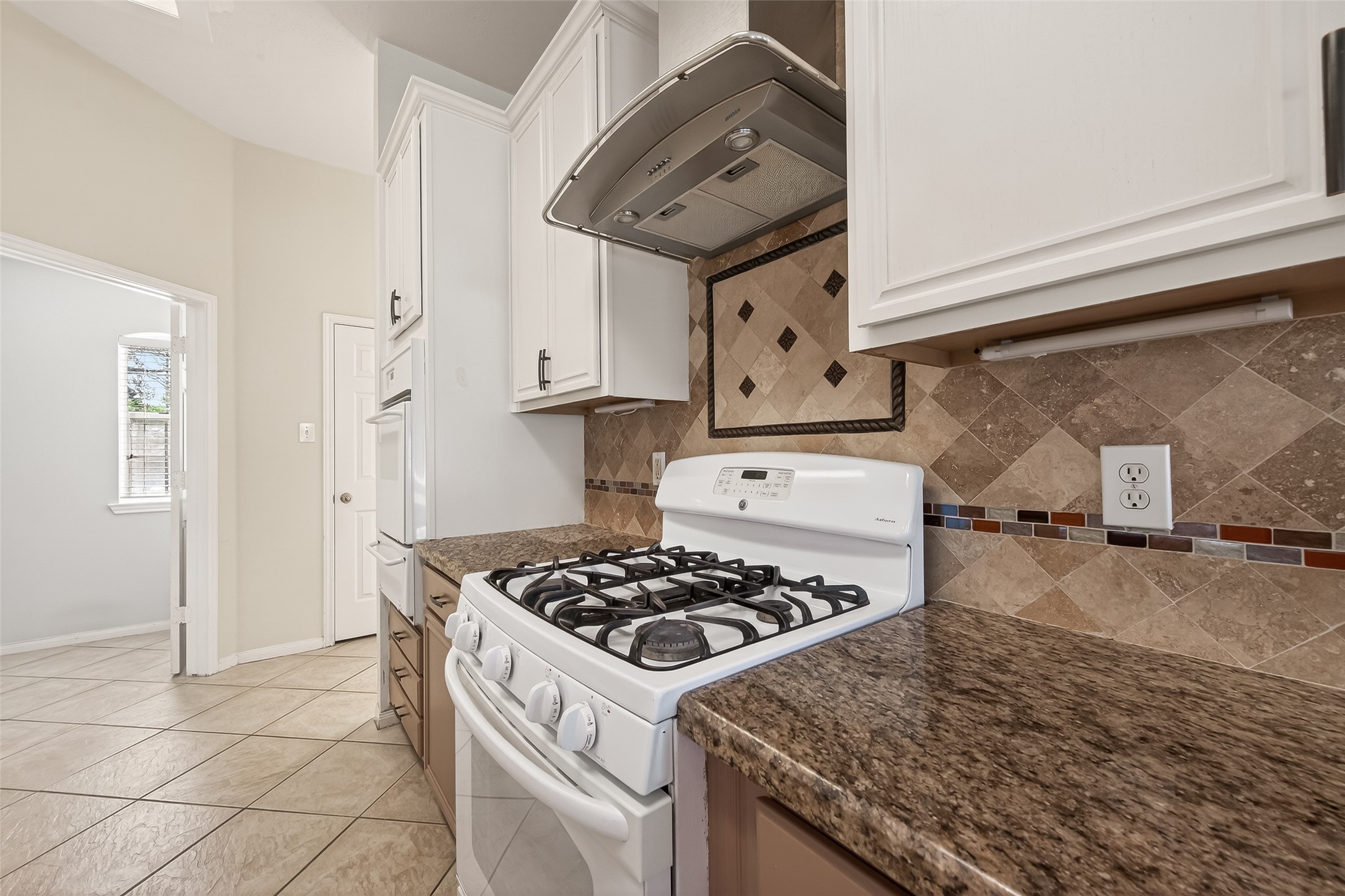 20839 Rivershire Lane Houston, TX 77073 - Photo 21 of 50 a kitchen with granite countertop a stove and a sink