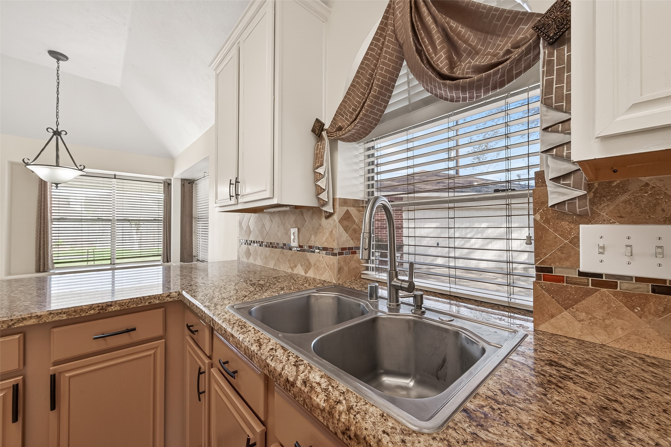 20839 Rivershire Lane Houston, TX 77073 - Photo 23 of 50 a kitchen with a sink a cabinets and window