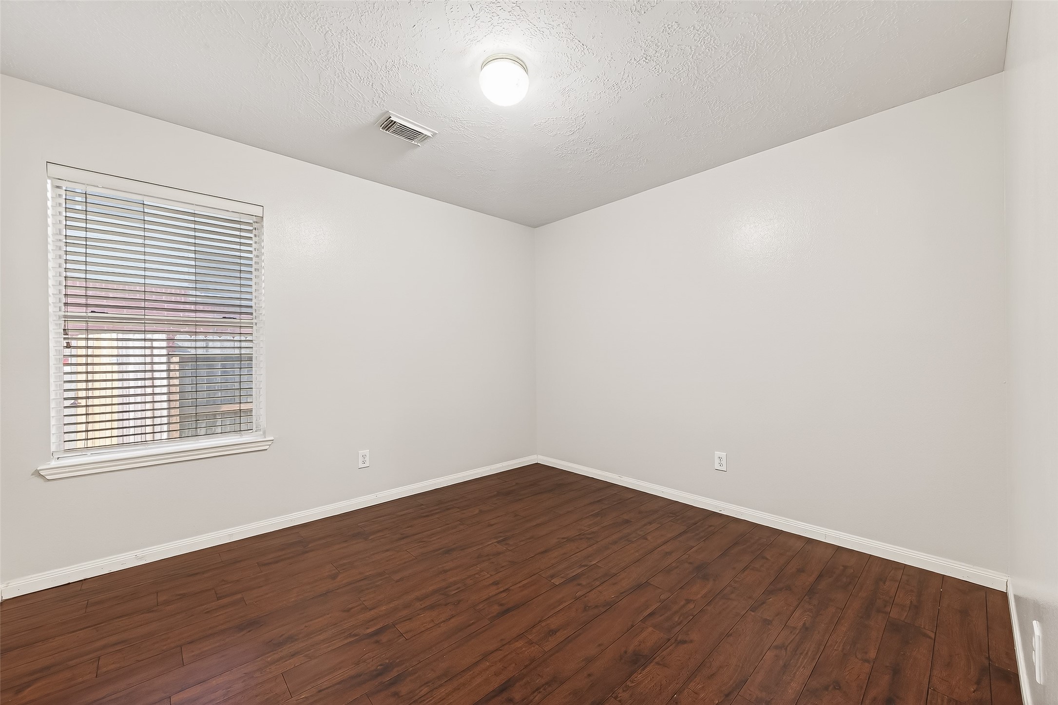 20839 Rivershire Lane Houston, TX 77073 - Photo 31 of 50 an empty room with wooden floor and windows