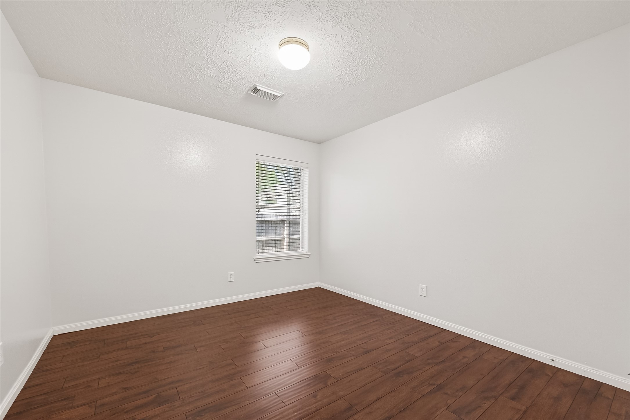 20839 Rivershire Lane Houston, TX 77073 - Photo 36 of 50 an empty room with wooden floor and windows