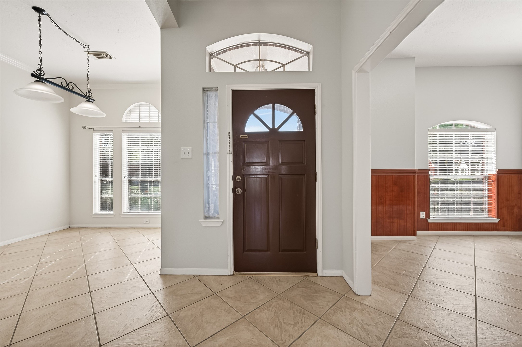 20839 Rivershire Lane Houston, TX 77073 - Photo 6 of 50 a view of an empty room with a window and a chandelier