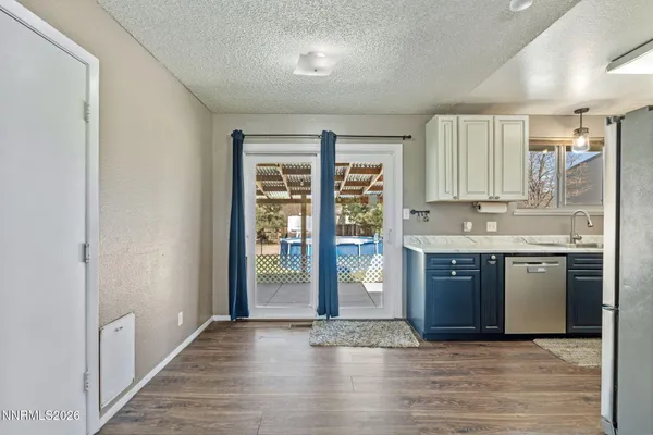 a kitchen with a refrigerator a stove top oven and sink