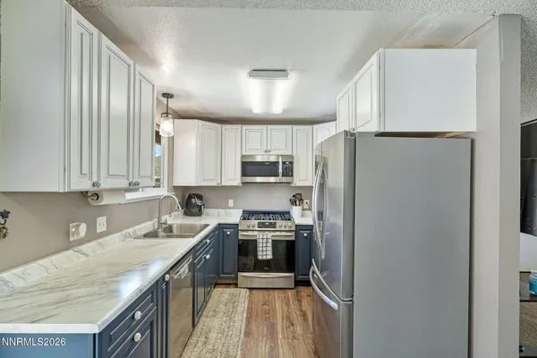 a kitchen with stainless steel appliances a refrigerator stove and sink