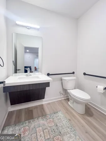 a bathroom with a bathtub sink mirror and toilet