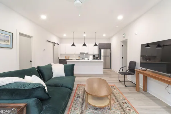 a living room with furniture and a flat screen tv